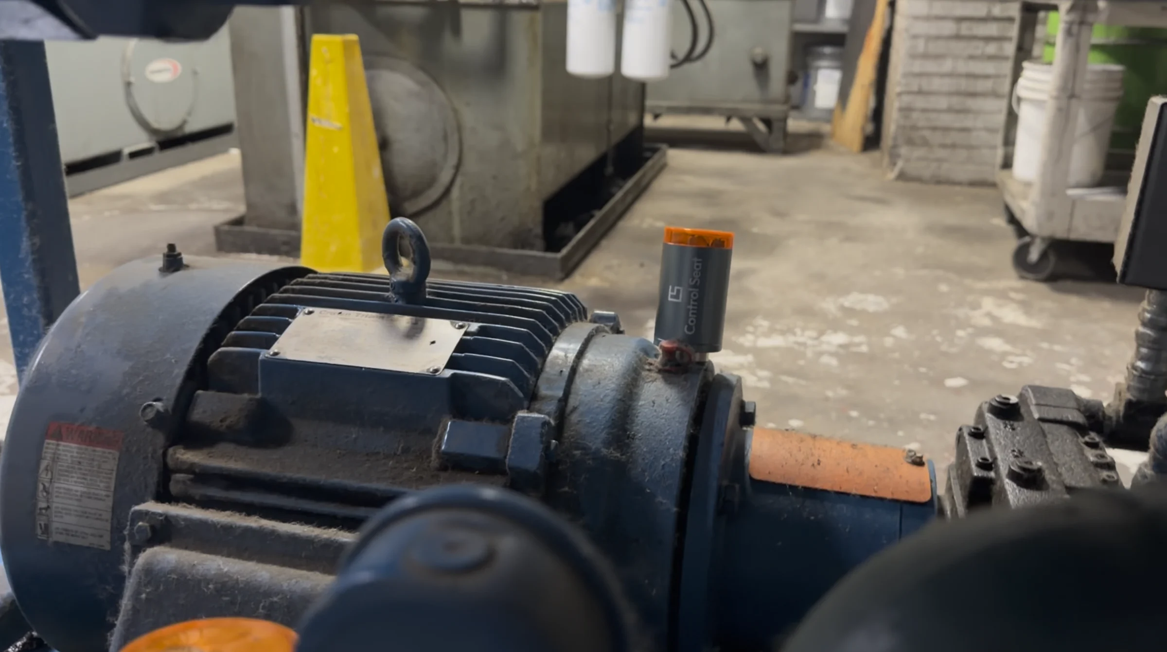 Control Seat sensor mounted on a blue industrial motor